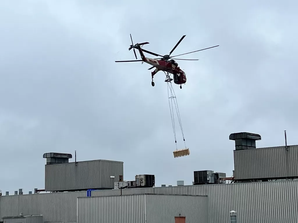 Helicopter lift operation over a commercial facility